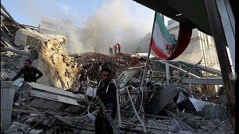Emergency services work at a building hit by an Israeli strike in Dmascus, Syria.