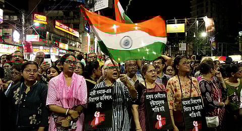 People raise slogans during a protest over the alleged sexual assault and murder of a trainee doctor, in Kolkata, Sunday, Sept. 8, 2024.