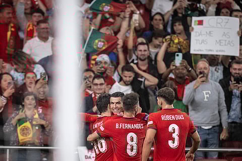 Portugal’s forward Cristiano Ronaldo (C) celebrates with his teammates after scoring during the UEFA Nations League football match, group A, between Portugal and Scotland at Luz stadium in Lisbon on September 8, 2024.