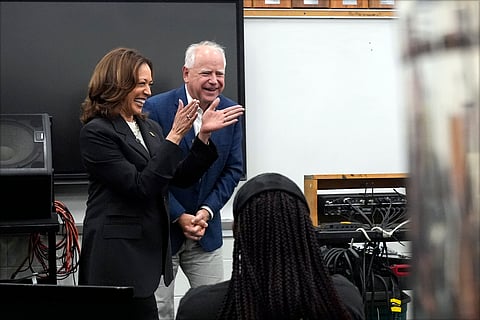 Republican presidential nominee former President Donald Trump gestures as he departs a campaign event at Central Wisconsin Airport.