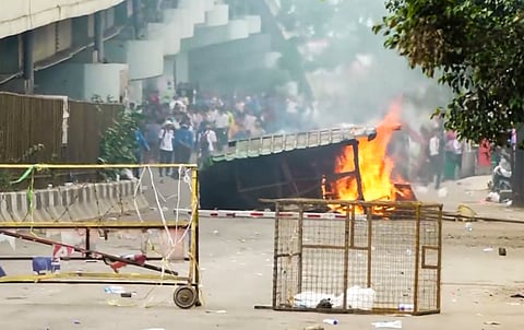 Members of All Manipur Students' Union (AMSU) charge towards a CRPF convoy during a protest march against the recent violence in the state, in Imphal.