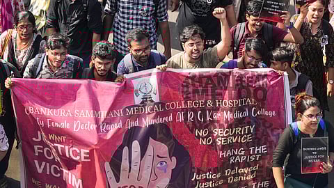 Junior doctors shout slogans as they march towards Swasthya Bhawan during a protest over RG Kar Hospital's rape and murder incident, in Kolkata.