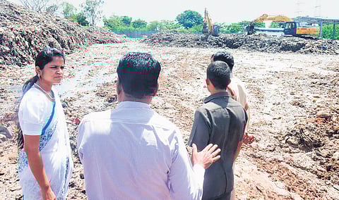 District Collector Valluru Kranthi inspects the dumpyard on the outskirts of Fasalwadi village near Sangareddy district headquarters on Thursday