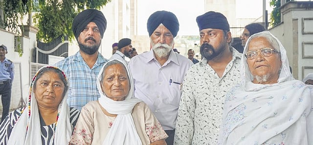 Family members of victims of 1984 anti-Sikh riots outside court on Friday