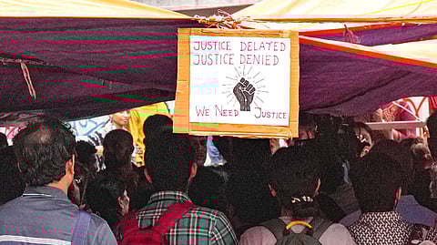FILE - A poster hangs at the protest site as junior doctors continued their 'cease work' and sit-in demonstration against the RG Kar Hospital incident for the third consecutive day, outside Swasthya Bhavan in Kolkata, 