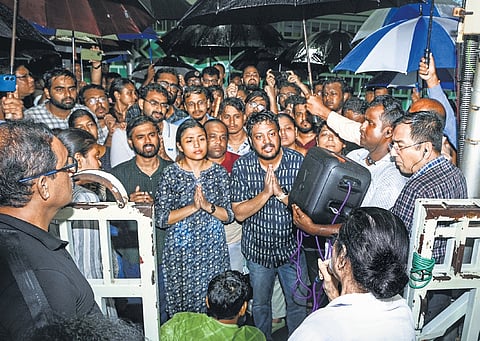 Junior doctors take part in a protest march to Swasthya Bhavan over the alleged sexual assault and murder of a trainee doctor, amid rain, in Kolkata.