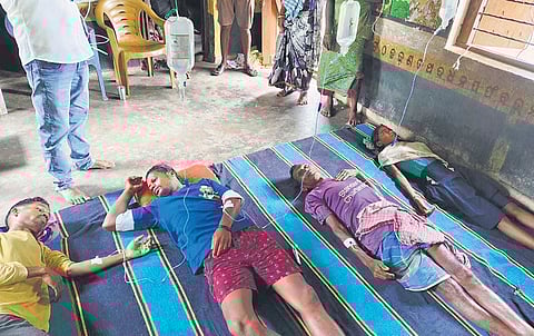 Affected villagers lying after being administered medicines by the health team 