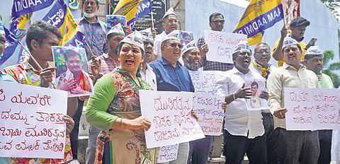 Aam Aadmi Party members protest against BJP MLA Munirathna at  Freedom Park in Bengaluru on Monday 