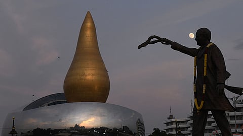Statue of former Prime Minister Rajiv Gandhi with the full moon rising in the background near the Martyrs Memorial, unveiled by Chief Minister Revanth Reddy.