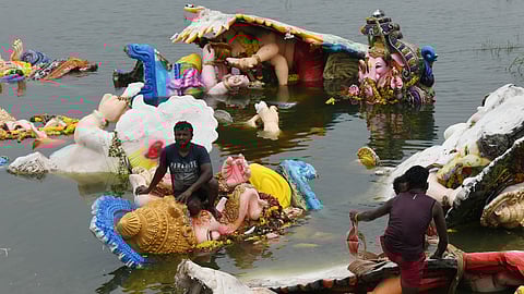 GHMC Workers clearing the immersed Ganesh idols at Kapra lake in Secunderabad.