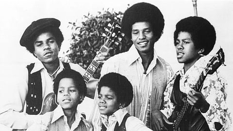 The Jackson 5, Michael Jackson, front right; Marlon Jackson, front left; Tito Jackson, back left; Jackie Jackson, back center; and Jermaine Jackson, back right; pose for this undated photo together in Los Angeles. 