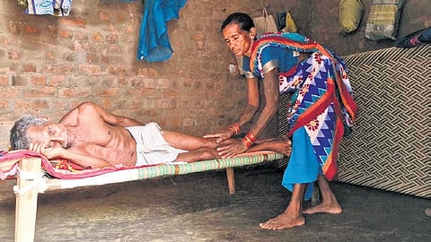 A woman taking care of her paralytic husband at Paraskhol village 