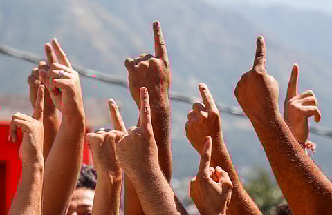  Voters show their fingers marked with indelible ink after casting votes during the first phase of Jammu and Kashmir Assembly elections, in Kishtwar, Wednesday, Sept. 18, 2024. 