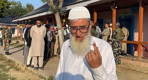 An elderly voter shows his finger marked with indelible ink after casting vote during the first phase of Jammu and Kashmir Assembly elections, at Kakapora, in Pulwama district, Wednesday, Sept. 18, 2024. 