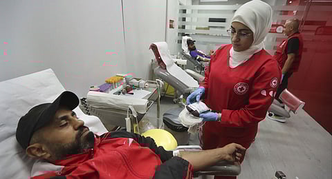 People donate blood for those who were injured by their exploded handheld pagers, at a Red Cross center, in the southern port city of Sidon, Lebanon, Tuesday, Sept. 17, 2024. 