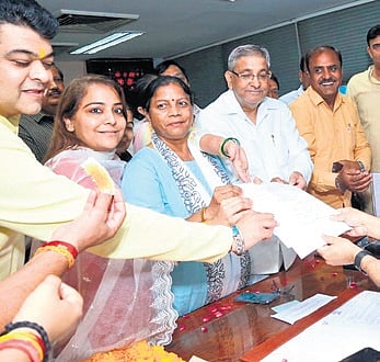 AAP’s Nirmala Kumari (left) and BJP’s Sunder Singh file nominations