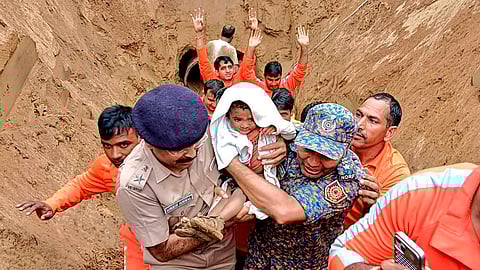 A 2-year-old child, trapped in a 35 feet deep pit, being rescued by NDRF and SDRF personnel, in Dausa, Rajasthan.