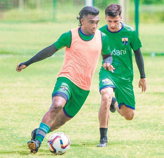 Midfielder Manoj M
in action during a practice session