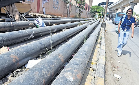 This footpath at Nayandahalli is completely blocked by pipes, forcing people to walk on the busy Mysuru Road 