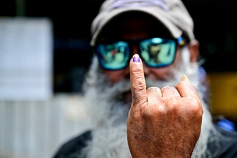 A voter shows his inked finger after casting his ballot at a polling station during voting in Sri Lanka's presidential election in Colombo on September 21, 2024.