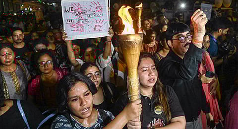 Members of Citizen Forum participate in torch rally against the alleged rape and murder of trainee doctor, in Kolkata, Friday, Sept. 20, 2024. 