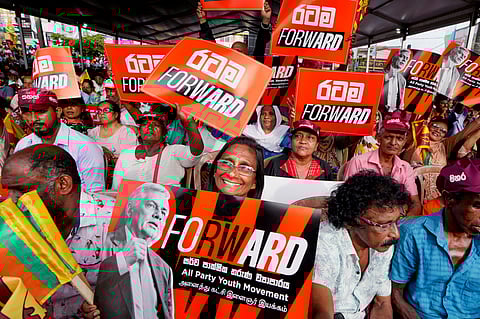 A woman supporter of Sri Lankan President and independent presidential candidate Ranil Wickremesinghe, holds a placard at an election rally in Minuwangoda, Sri Lanka, Tuesday, Sept. 17, 2024.