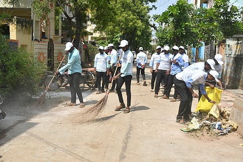 Students and sanitation workers take part in the massive cleanliness drive as a part of Swachhta hi Seva campaign at Singh Nagar in Vijayawada on Tuesday.