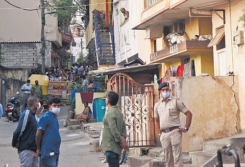 A police officer watches over the scene of crime in Vyalikaval 