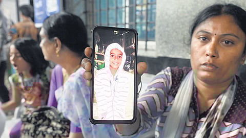 The gate which fell on Niranjan at Rajashankar Playground on Sunday; Priya shows a picture of her son 