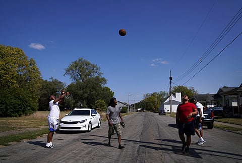 Springfield native Jaheim Almon, left, plays basketball with a group of neighbors in Springfield,