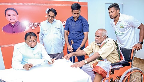 CM Mohan Majhi takes note of the problems faced by an elderly man on Monday