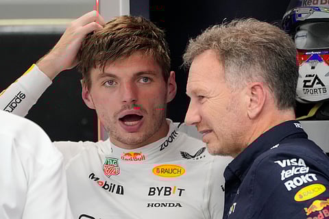 Red Bull driver Max Verstappen of the Netherlands, left, talks to team principal Christian Horner during the second practice session of the Singapore Formula One Grand Prix at the Marina Bay Street Circuit, in Singapore.