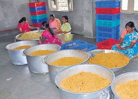 Workers prepare laddus at Sri Raja Rajeshwara Swamy Devasthanam in Vemulawada on Tuesday