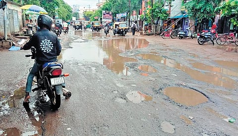 Rainwater-filled potholes dotting the Station Bazaar road in Cuttack