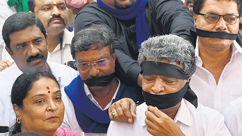 Members of various groups hold a silent protest in support of Chief Minister Siddaramaiah in Bengaluru on Wednesday
