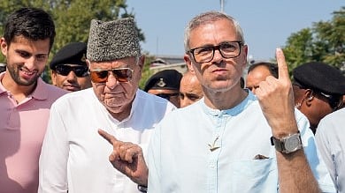 Jammu and Kashmir National Conference (JKNC) President Farooq Abdullah and Vice President Omar Abdullah show their fingers marked with indelible ink after casting vote during the second phase of J&K Assembly elections, in Srinagar, Wednesday, Sept. 25, 2024.