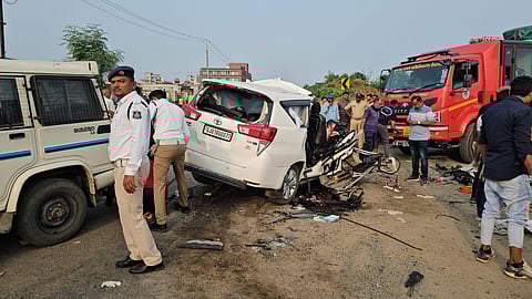 Police and people near the accident site after a collison between a car and trailer at Himmatnagar, in Sabarkantha, Wednesday, Sept. 25, 2024.