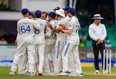 Indian players celebrate the dismissal of Bangladesh's Shadman Islam during the first day of the second test cricket match between India and Bangladesh, at Green Park stadium in Kanpur