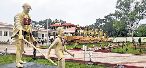 Life-size sculptures of Mahatma Gandhi with a boy and the Dandi March