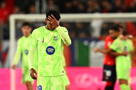 Barcelona's Lamine Yamal reacts at the end of a Spanish La Liga soccer match after loosing against Osasuna at El Sadar stadium in Pamplona.