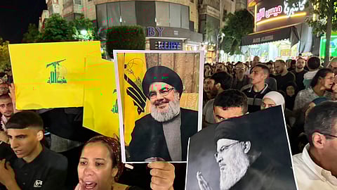 Representative Image: Palestinian protesters carry Hezbollah flags and posters with a picture of Hezbollah leader Sayyed Hassan Nasrallah during a rally in support of Hezbollah, in the West Bank city of Ramallah Saturday, Sept. 28, 2024.