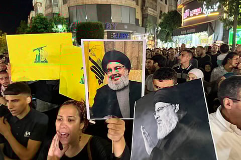 FILE - Hezbollah leader Sheik Hassan Nasrallah, speaks to the crowd in a rare public appearance during Ashura, that marks the death of Shiite Islam's Imam Hussein, in the suburbs of Beirut, Nov. 14, 2013. (AP Photo/Bilal Hussein, File)