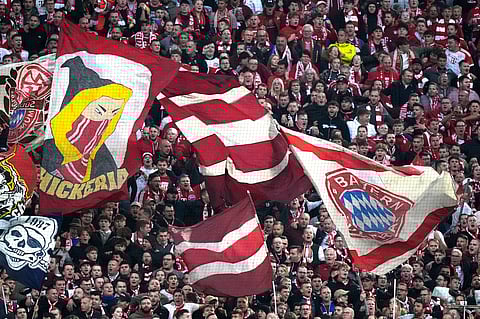 Supporters cheer during the Bundesliga soccer match between Bayern Munich and Leverkusen at the Allianz Arena in Munich, Germany, Saturday, Sept. 28, 2024. 