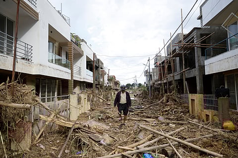 A man walks on a street strewn with debris in Kathmandu, Nepal, Monday, Sept. 30, 2024 in the aftermath of a flood caused by heavy rains.
