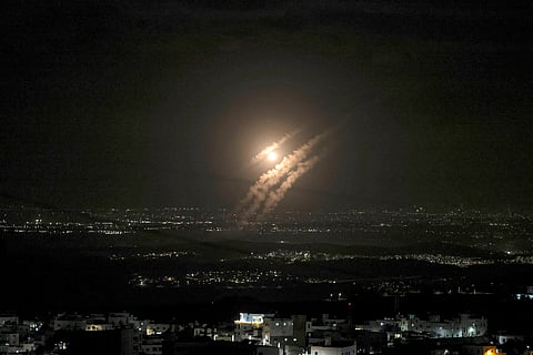 Fireworks explode next a portrait of slain Hezbollah leader Hassan Nasrallah and a minaret of a mosque in an anti-Israeli gathering celebrating Iran's missile strike against Israel, at Felestin (Palestine) Sq. in Tehran, Iran.