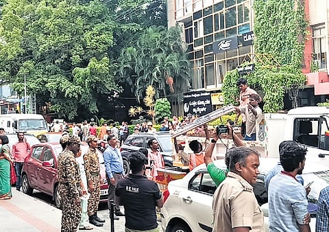 BBMP workers, accompanied by marshals and police personnel, clear the encroachments from footpaths on Church Street on Friday 