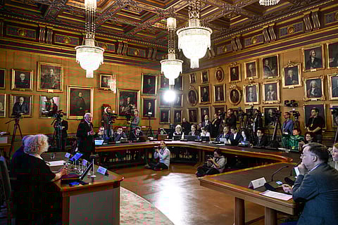 Mats Larsson, member of the Royal Academy of Sciences, standing at left, speaks during the announcement of the winner of the 2023 Nobel Prize in Physics, at the Royal Academy of Sciences, in Stockholm, on Oct. 3, 2023.