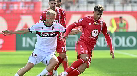 AC Monza's Daniel Maldini, right, and Bologna's Jens Odgaard, left, challenge for the ball during a Serie A soccer match between Monza and Bologna in Monza, Italy