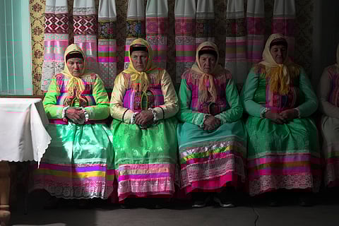Women in traditional Doukhobor dresses pray at the former Orphanage house where Doukhobors has worshiped for years, on Easter in the remote mountain village of Gorelovka, Georgia