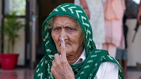 An elderly voter shows her inked finger after casting vote during the Haryana Assembly elections, at Badsa village in Badli tehsil of Jhajjar district, Haryana, Saturday.